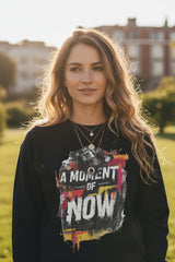 Black sweatshirt with 'A Moment of Now' graphic design on a white background